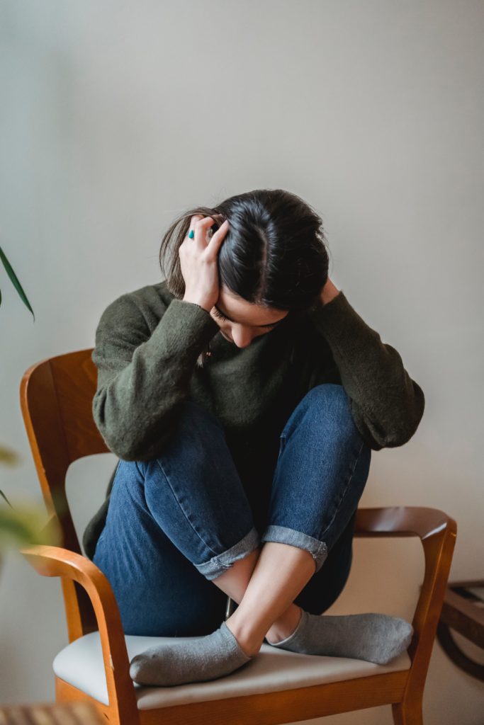 girl holding head